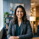 A professional portrait of a happy South Asian woman smiling, representing a satisfied customer.